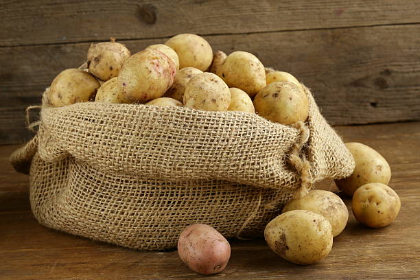 istock fresh organic potatoes on a wooden background 477935669
