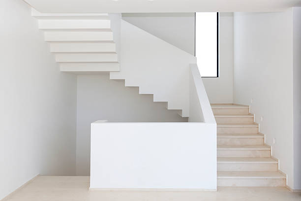 istock Narrow staircase in the white corridor 477936212