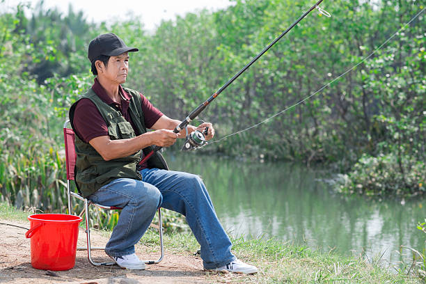 Copy-spaced image of a senior man fishing in the countryside