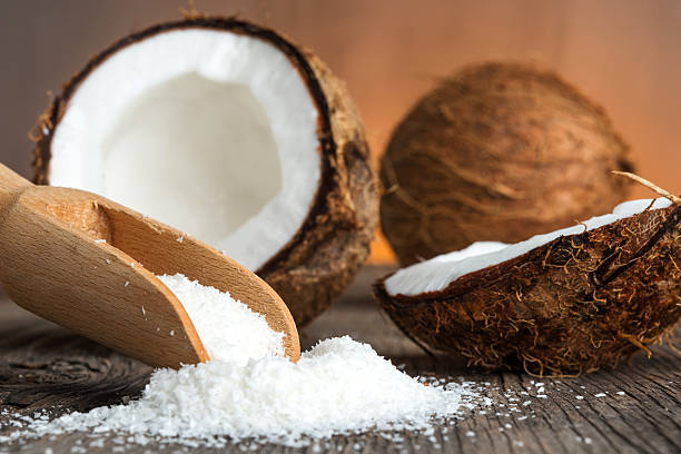 istock Coconut and coconut flakes on wood 477939700