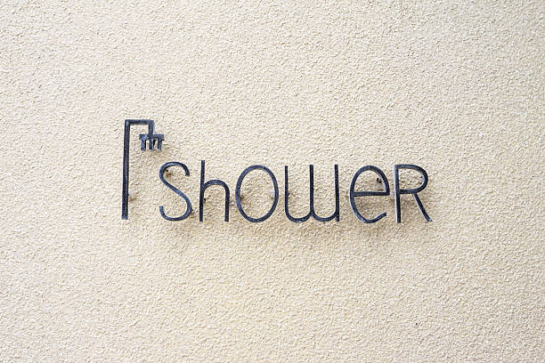 shower sign shower sign on sand wall shower women falling water human face stock pictures, royalty-free photos & images