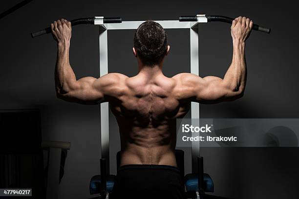 Young Male Bodybuilder Doing Heavy Weight Exercise Stock Photo - Download Image Now - Active Lifestyle, Adult, Anaerobic Exercise
