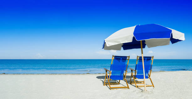 istock sun loungers and a beach umbrella on silver sand 477940682