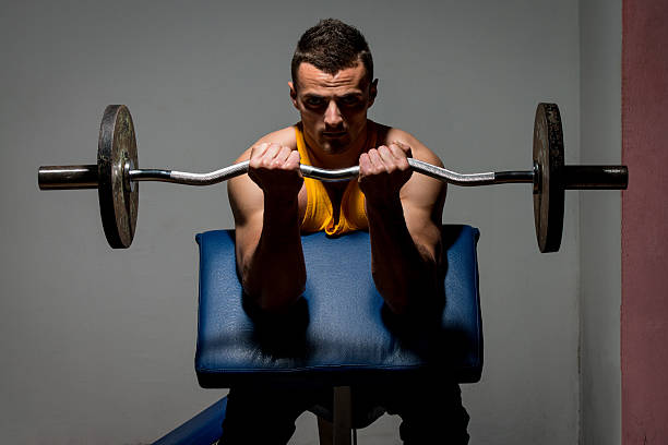 istock fitness trainer doing heavy weight exercise for biceps 477941287