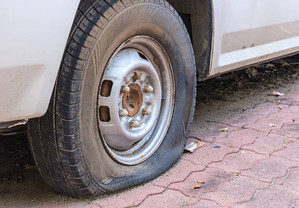 istock Deflated damaged tyre on car wheel 477943536