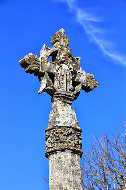 istock Christian stone cross with blue sky background 477945219