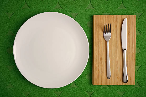 istock Modern Cutlery set on green fabric background 477945946
