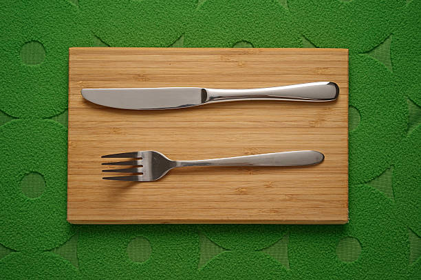 Modern Cutlery set on green fabric background stock photo
