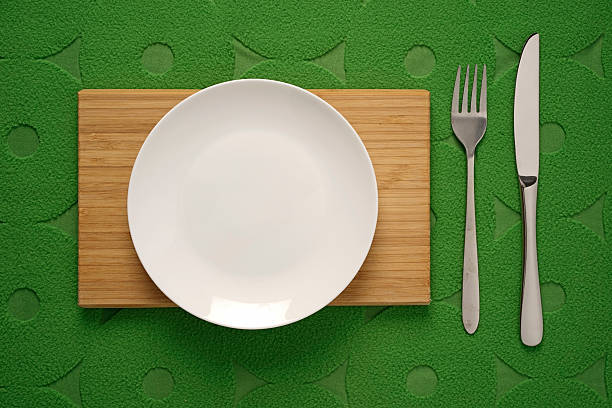 istock Modern Cutlery set on green fabric background 477945950