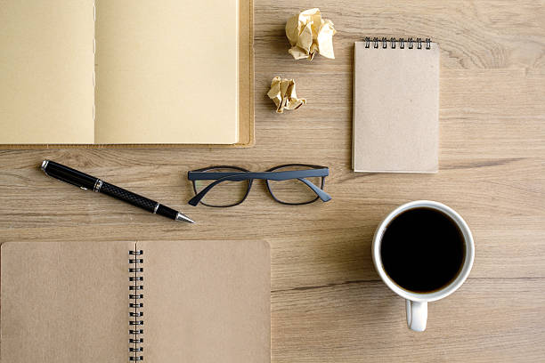 istock Cup of coffee with notebook on desk 477947102
