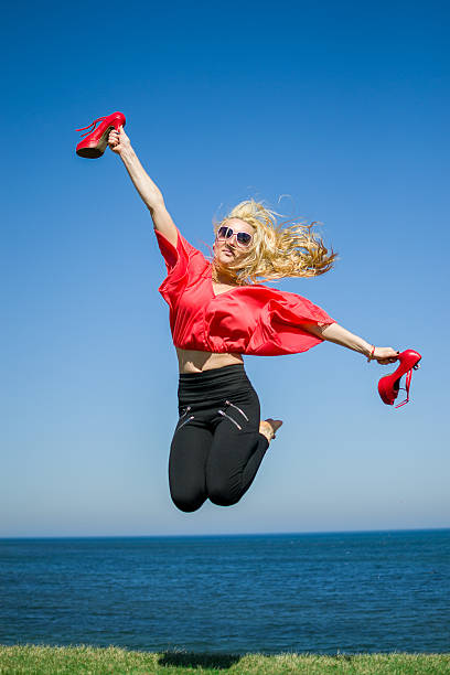 Girl jumping in the water stock photo