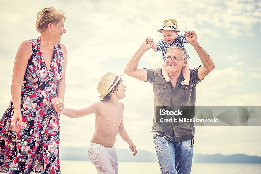 Grandparents And Grandchildren Enjoying Beach Holiday 2015 Stock Photo
