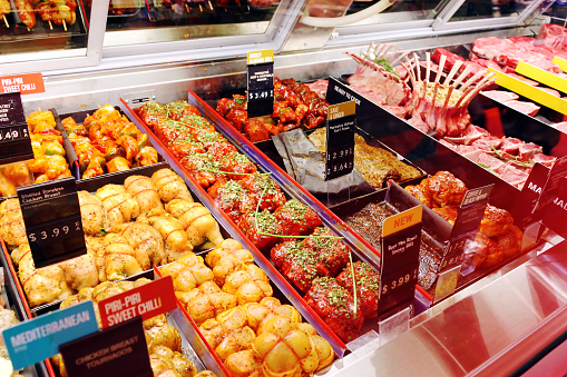 Selection of different cuts of fresh raw meat and ready-to-cook meals in a supermarket