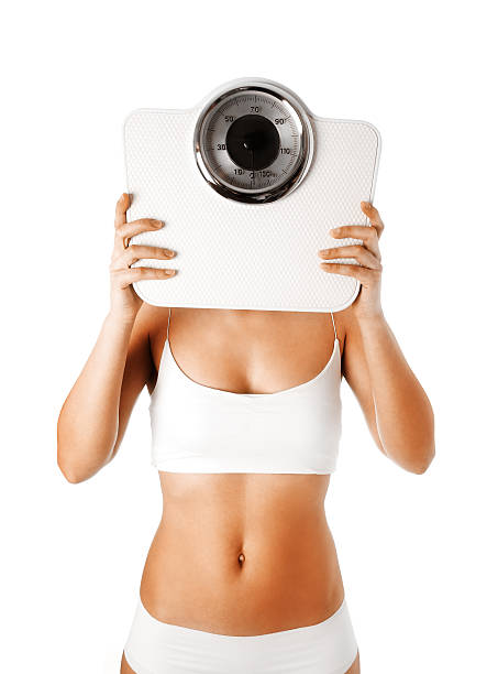 istock woman holding a balance in his face 477951995