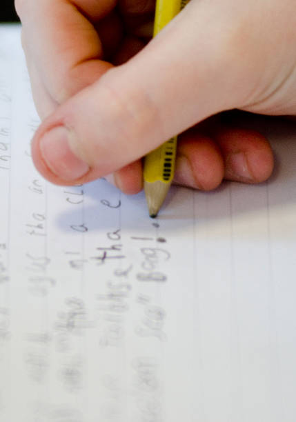istock child's hand writing in Gaelic 477952516
