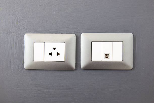 istock electric plug and network ethernet port on wall 477952904