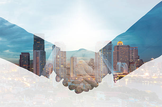 istock double exposure handshake between businessman on a city backgrou 477952948