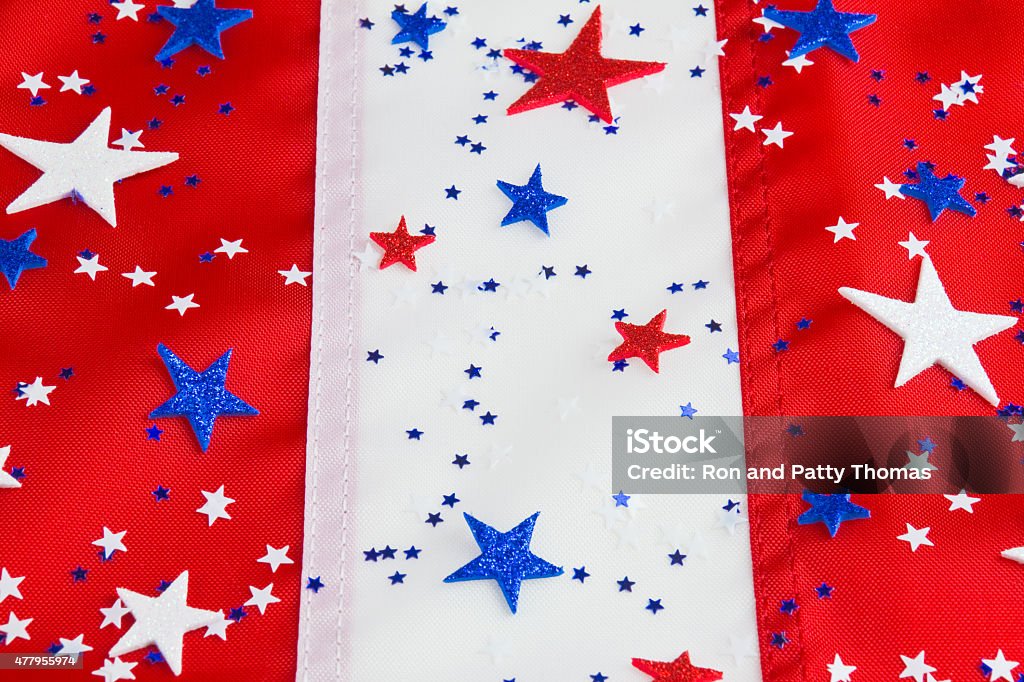 American flag close up with star confetti (P) American Flag With Star Confetti close up with only part of flag showing. The red and white stripes show only and are coming straight forward.. Big and little confetti stars cover the flag. 2015 Stock Photo