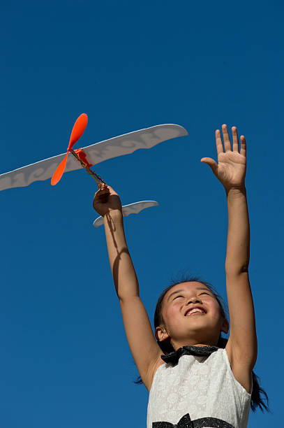istock Girl Playing With Toy Airplanes 477956323