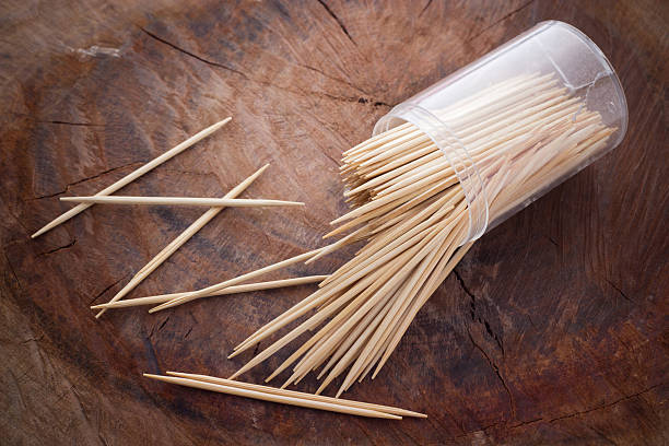 Toothpicks Wooden Toothpicks on wood background toothpick stock pictures, royalty-free photos & images