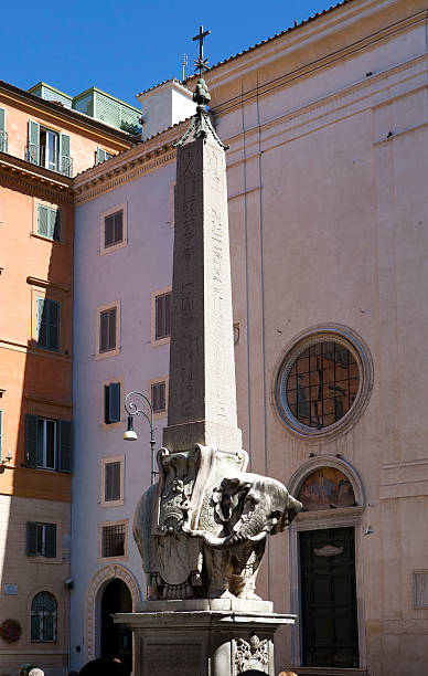 istock elephant statue and egyptian obelisk, Rome. Italy 477959844