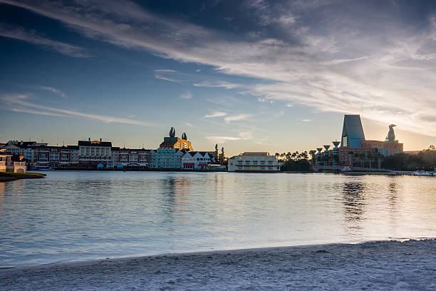 Boardwalk Disney  area with Swan and Dolphin hotel Orlando, FL, USA - January 15, 2012: Boardwalk Disney  area with Swan and Dolphin hotel on Crescent Lake shore at sunset in Orlando on January 15, 2012. disney world stock pictures, royalty-free photos & images