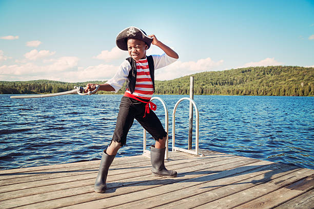 istock African-american child dressed as pirate on a lake. 477962255