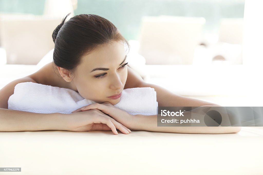 Beautiful young woman relaxing after massage. Spa Woman. Beautiful young woman relaxing after massage. Achievement Stock Photo