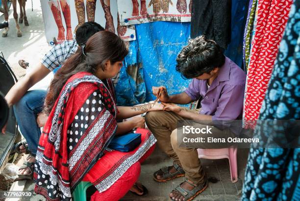 Indian Man Painting Henna Paste On Womans Hand Stock Photo - Download Image Now - 2015, Abstract, Adult