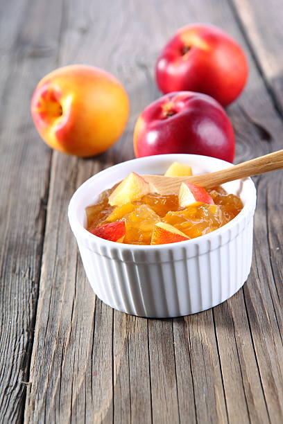 nectarines and jam on wooden background stock photo