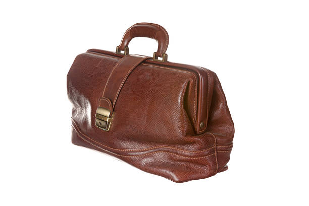 Antique doctor's bag in cowhide filled with medical instruments