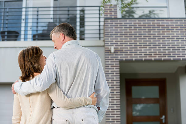 istock Mature couple looking at a house 477965389