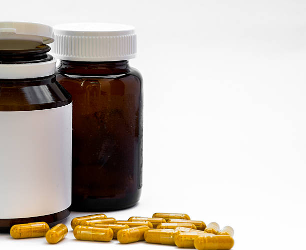 istock Herb capsule spilling out of pill a bottle 477968992