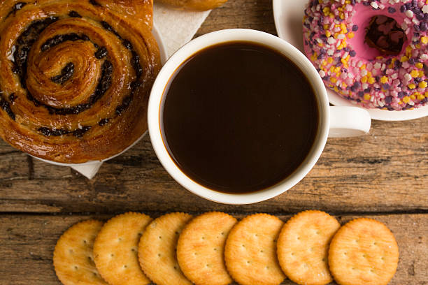 istock Cup of coffee on a wooden board and biscuits 477969418