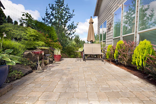 Backyard Paver Patio with Garden Accessories Garden Backyard Paver Patio with Chairs Umbrella Plants Pots Trees and Decoration hardscape photos stock pictures, royalty-free photos & images
