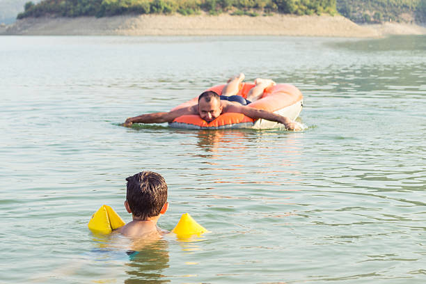 istock Father and son on the lake 477970705