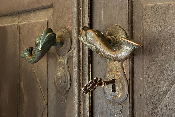 istock big old key in the door with fish handles 477970957