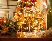 Bottle of Wine and Glasses against Christmas Lights