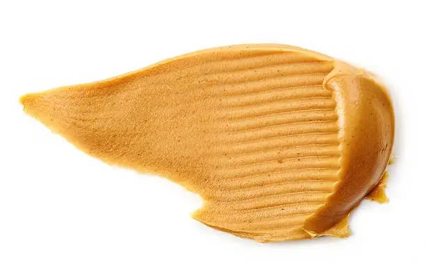 Photo of peanut butter spread isolated on white