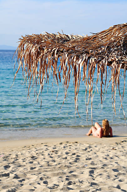 istock Woman lies on the beach 477972474