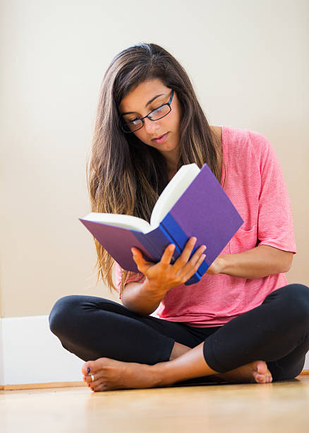 istock happy young woman reading a book 477973191