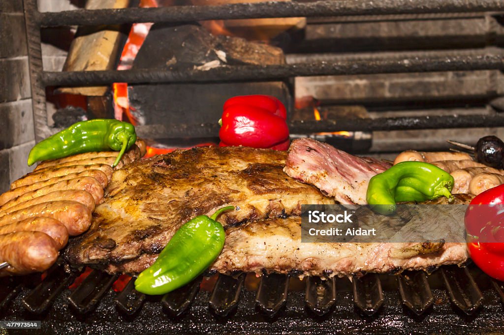 Grilled lamb ribs and spicy pork sausage Grilled lamb ribs and spicy pork sausage with peppers on grill 2015 Stock Photo