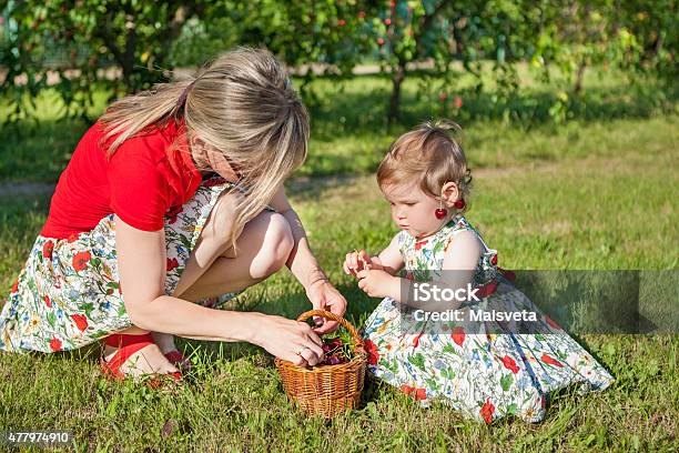Mother And Little Daughter In Garden Stock Photo - Download Image Now - 2015, Adult, Baby - Human Age