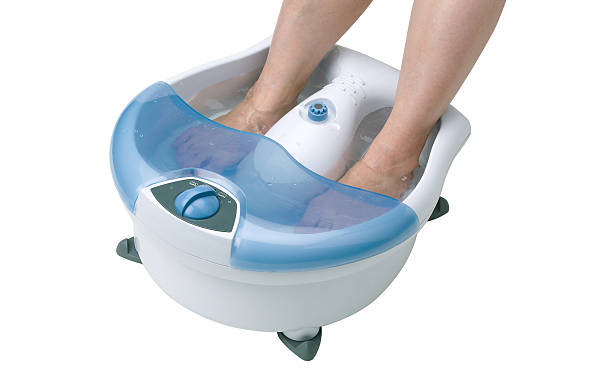 istock Woman's feet in a vibrating feet massager 477978316