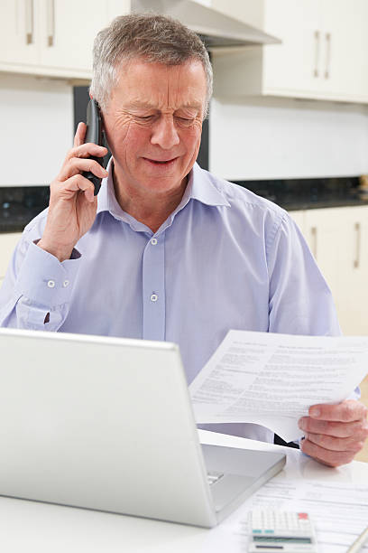istock Unhappy Senior Man On Phone Querying Bill 477978709