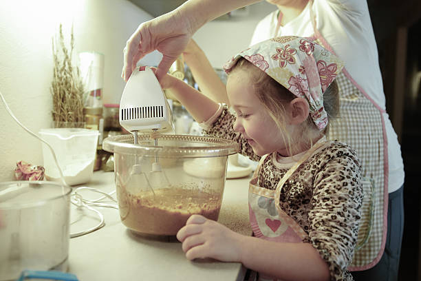 istock Mother and daughter preparing dough in the kitchen 477979202