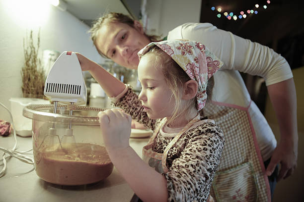 istock Mother tutoring her daughter in the kitchen 477979208