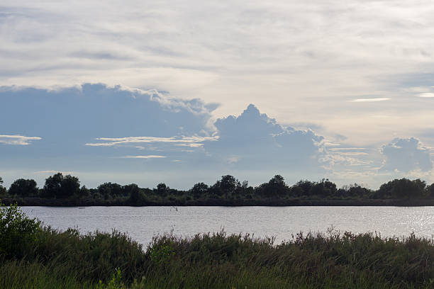 istock Silhouette riverscape with clouds in the sky. 477980372
