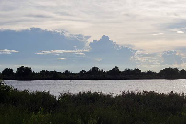 istock Silhouette riverscape with clouds in the sky. 477980382
