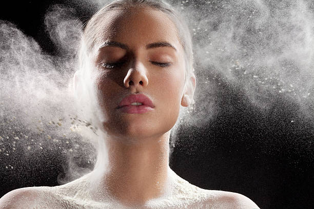 istock Make up powder splashing on the face 477980487